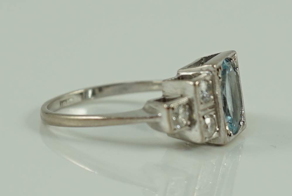 An 18ct white gold oval cut aquamarine and six stone diamond cluster set dress ring